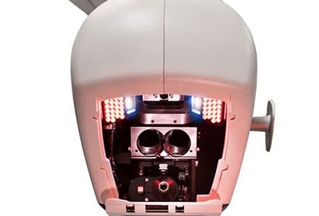 A close-up of a robotic head showcasing internal components, including cameras and LED lights, highlighting its advanced technology and functionality.