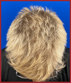 Short, textured blonde hair with a voluminous appearance against a bright blue background. The focus is on hairstyle texture and styling options.